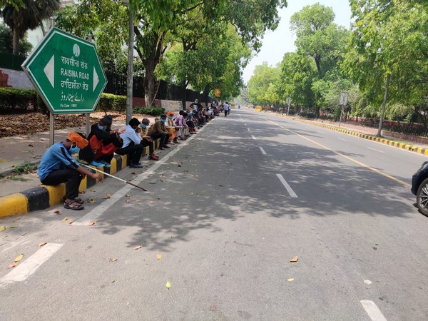 People waiting for the food at Raisina road in New Delhi [Photo/ANI]