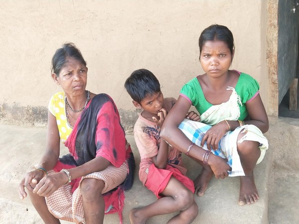 Dhule (L) sitting with her son and a wife outside her house in Pakhnachua village [Photo/ANI]