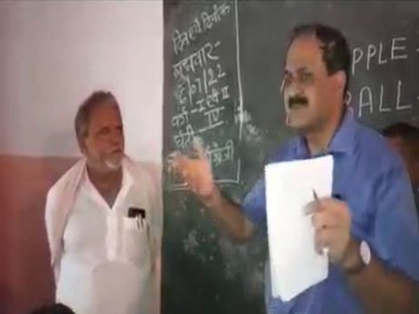 Visual of District Collector Sanjay Kumar Singh with a school principal in Lakhisarai, Bihar (Photo/ANI)