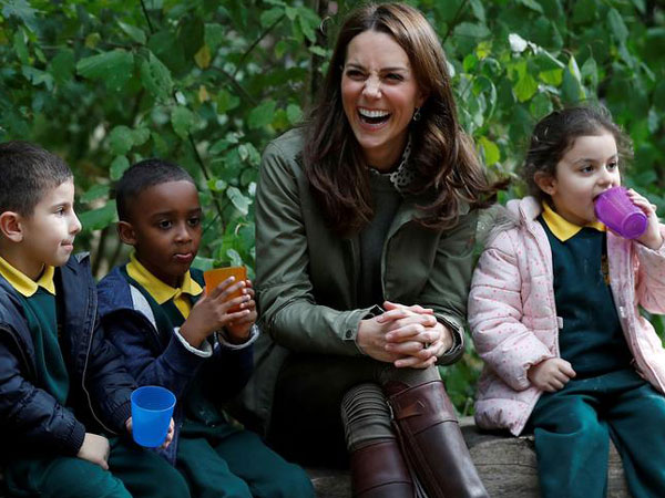 Kate Middleton sitting along few children 