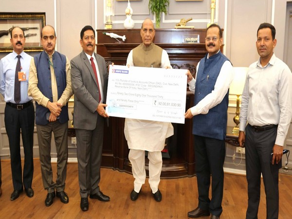 Commodore Siddharth Mishra (Retd), Chairman and Managing Director of BDL giving cheque to Defence Minister Rajnath Singh