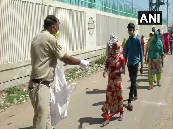 Delhi Police personnel distributing food packets in the national capital on Saturday.