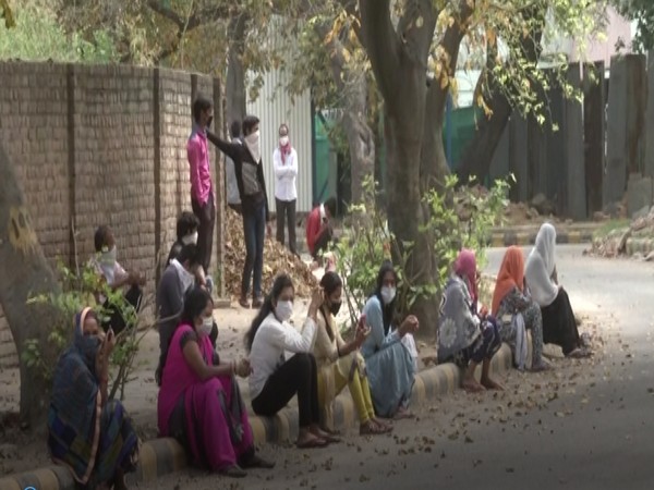 Women wait for food at a Delhi locality. Photo/ ANI