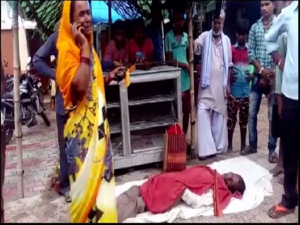 The woman along with her dead husband who were allegedly deboarded from a UPSRTC bus. Photo/ANI