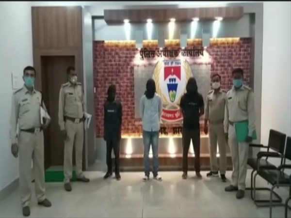 Officials of Jharkhand Police with arrested PLFI members