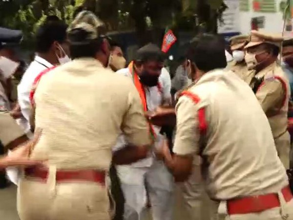 Police rescuing Bharatiya Janata Party (BJP) worker Abdul Adil. (Photo/ANI)