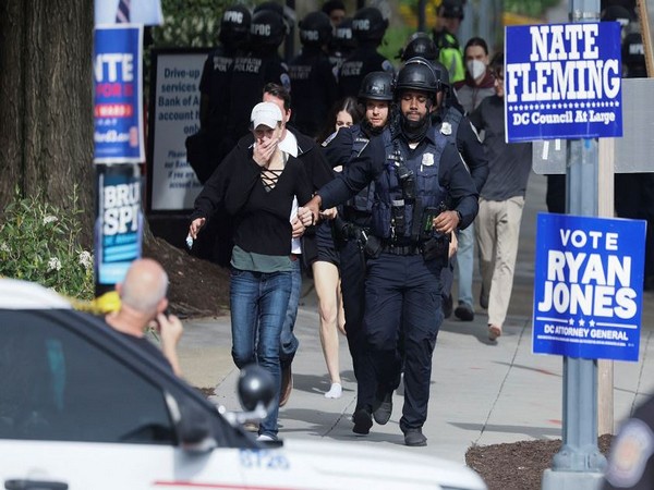 Police officers run with civilians as police evacuate people to safety at the scene of a reported shooting (Photo Credit: Reuters)