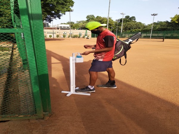 An athlete using sanitizer in Major Dhyan Chand National Stadium