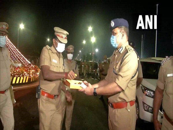 Police personnel on patrolling distribute sweets to mark New Year in Chennai (Photo/ANI)