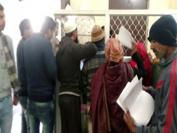 People waiting at the counter of the Hapur Municipal Corporation in Uttar Pradesh on Wednesday to receive their birth certificates. Photo/ANI