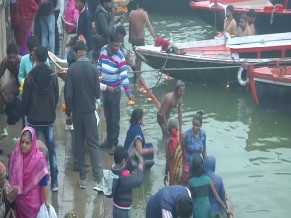Devotees taking a dip in Ganga in Varanasi. Photo/ANI