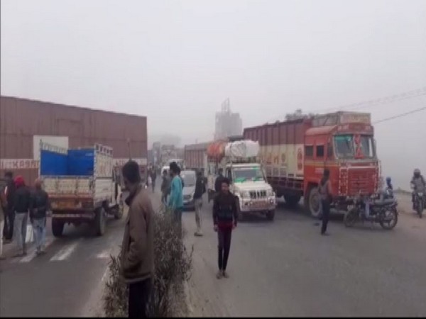 RJD workers blocked the National Highway 28 in Muzaffarpur (Photo/ANI)