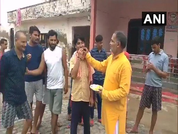 Shivali villagers distribute sweets after Vikas Dubey dies in police encounter. (Photo/ANI)