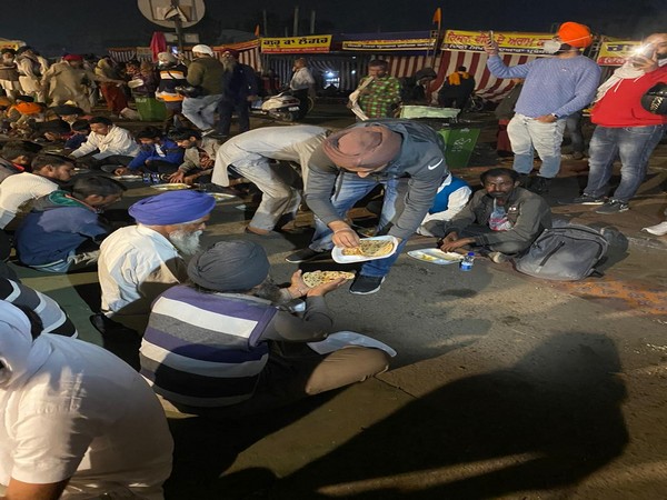 DU Students serving 'Langar' to farmers at Singhu border. (Photo/ANI)