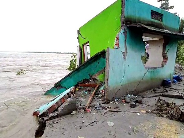 A house gets damaged due to the floods following heavy rainfall in Barpeta. (ANI Photo)