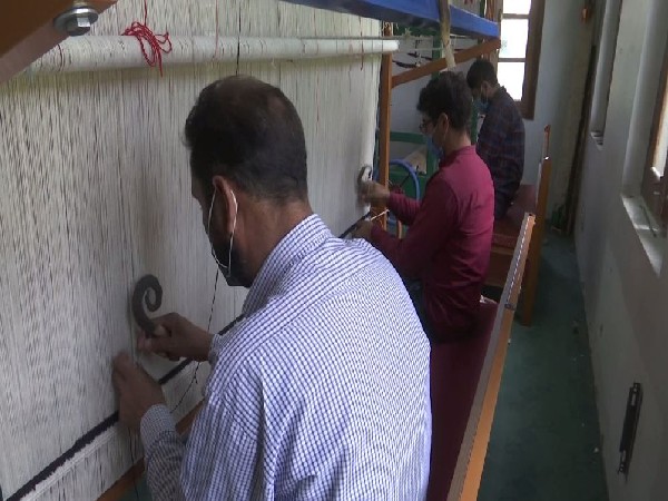Weavers processing yarn at IICT, Srinagar. (Photo/ANI)
