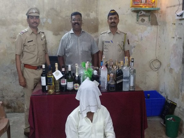 EC officials with seized liquor. 