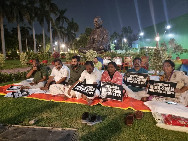 The 50-hour long day-night protest of suspended MPs continues at the Gandhi statue at Parliament. (ANI/photo)