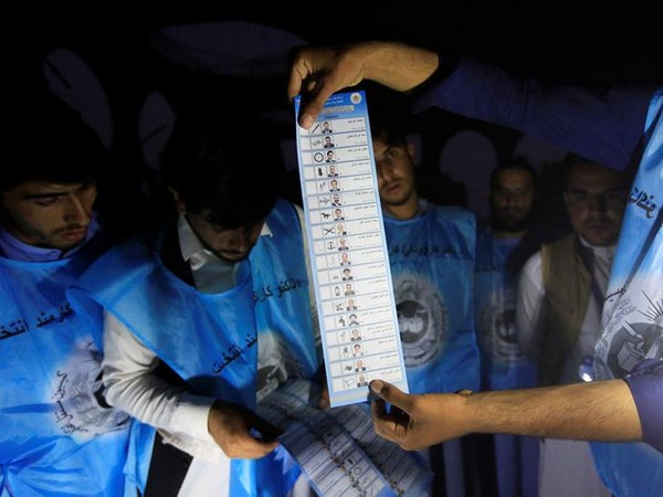 Afghan election commission workers count ballot papers of the presidential election in Jalalabad