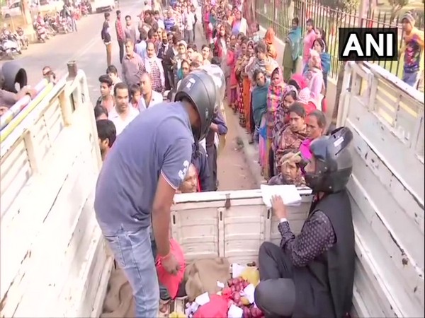 Biscomaun employees selling onions wearing helmets in Patna on Saturday 