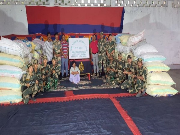 Visual of the officials with the seized ganja and accused. 