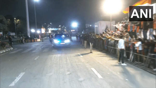People greet PM Modi as he holds a roadshow in Ahmedabad  (Photo/ANI)