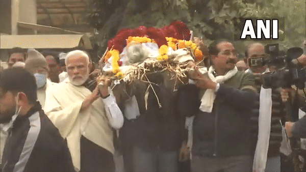 Prime Minister Narendra Modi carries the mortal remains of his late mother