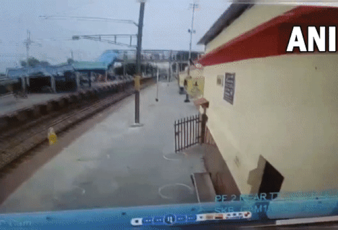 Visual of railway official saving the woman at Firozabad railway station in UP (Photo/ANI)