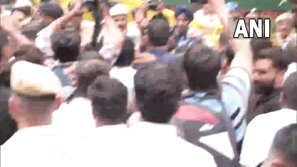 Congress leader Priyanka Gandhi Vadra jumps over a police barricade placed near AICC during party protest against price rise and unemployment in Delhi (ANI Visuals)