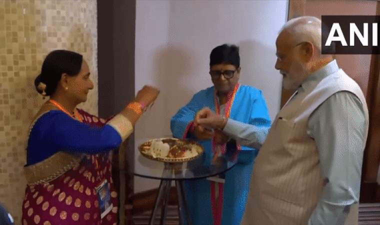 Indian Community Members tie 'Rakhi' to Prime Minister Narendra Modi in South Africa. (Photo: ANI)