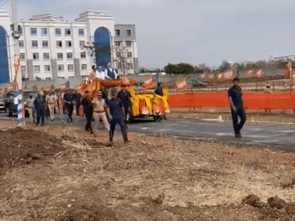 A visual of man trying to run towards PM Modi's convoy in Karnataka. He was caught and detained by police. (Photo/ANI)
