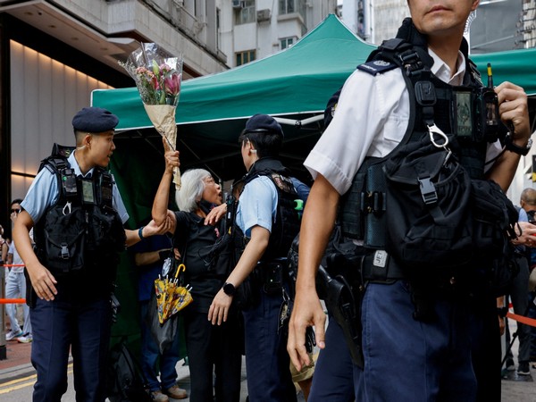 A June 2023 photo of a woman with flowers being detained on anniversary of 1989 Beijing's Tiananmen Square crackdown in Hong Kong (Photo/Reuters)