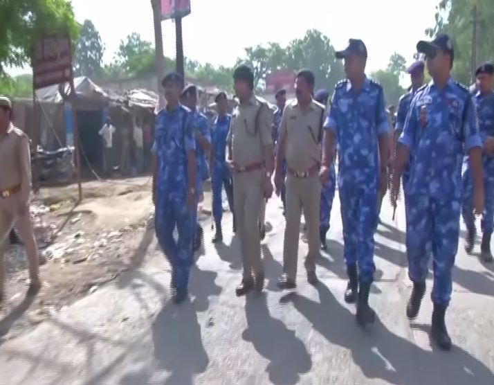A flag march was carried out by security forces in Tappal area of Aligarh on Sunday. (Photo/ANI)