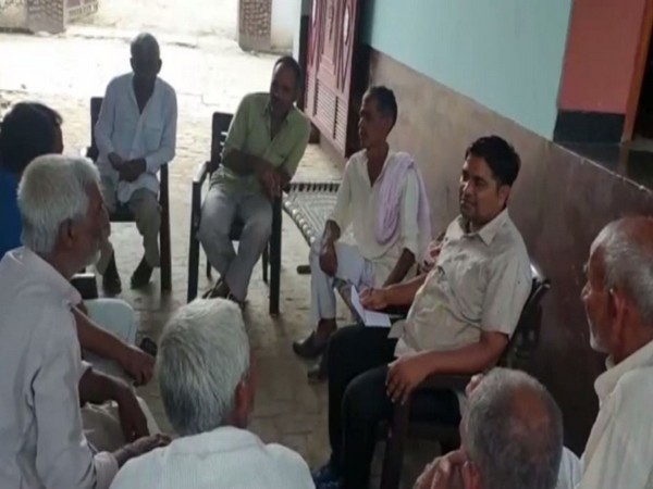 Villagers at the farmer's home in Hapur. Photo/ANI
