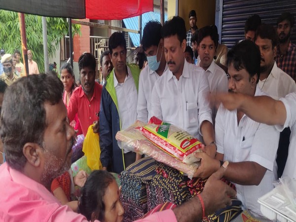 Tamil Nadu education minister distributing relief materials to the flood-affected people. (Photo/ANI)
