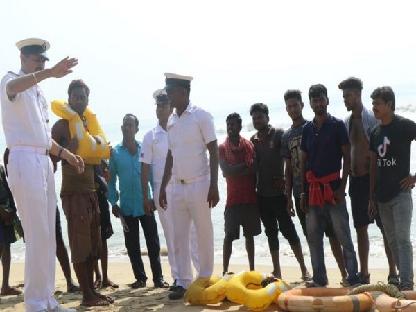 Indian Coast Guard personnel with locals on Odisha coast. Photo/ANI