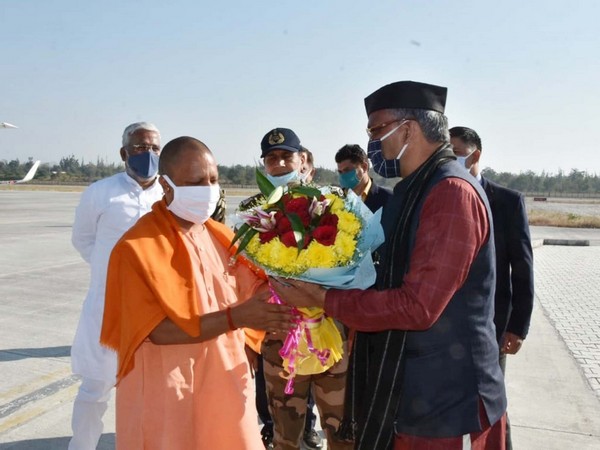 Uttarakhand Chief Minister Trivendra Singh Rawat welcomed UP CM Yogi Adityanath at Dehradun airport earlier today. [Photo/ANI]