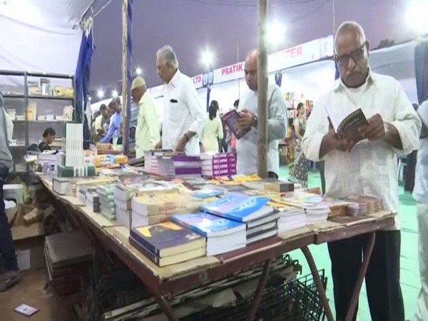 The visitors going on through different books on display in Telangana's Hyderabad book fair on Tuesday. Photo/ANI