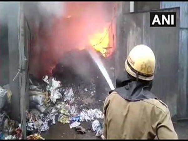 A fireman trying to douse the fire which broke out on Friday in Ludhiana. Photo/ANI