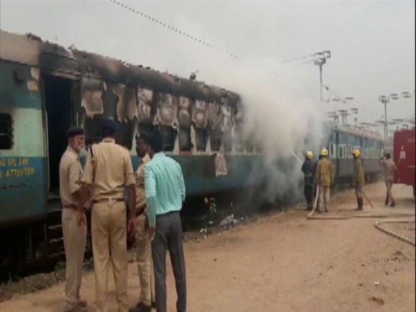 Fire officials dousing fire in the train compartments. Photo/ANI