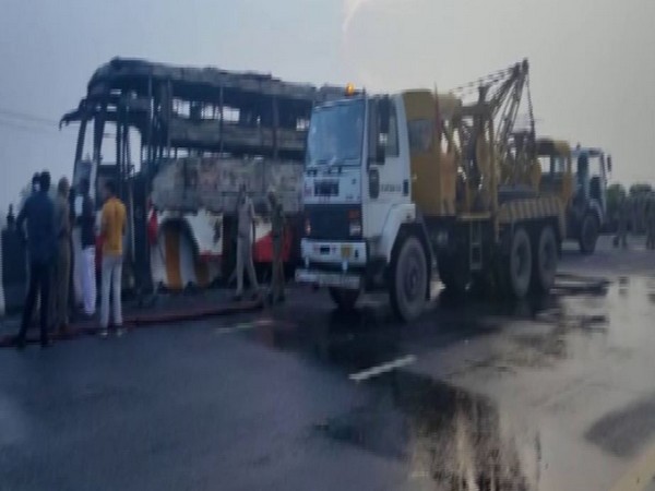 A private double-decker bus collided with a divider and caught fire on the Lucknow-Agra Expressway today morning. (Photo/ANI)