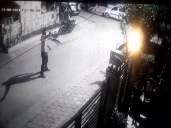 A visual from CCTV footage in which a man was seen firing at Indore resident Dilip Yadav's house. (Photo/ANI)