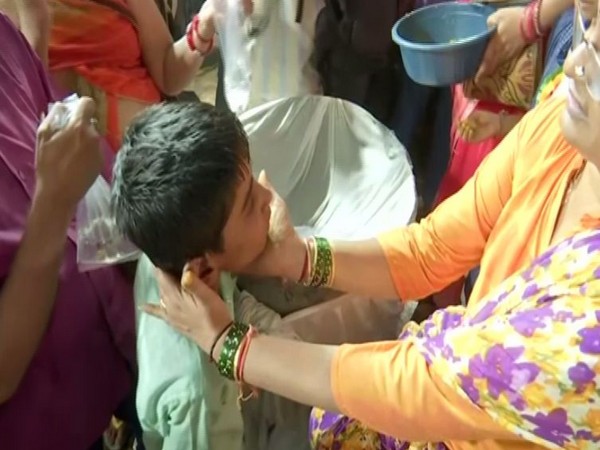A child taking fish prasadam. 