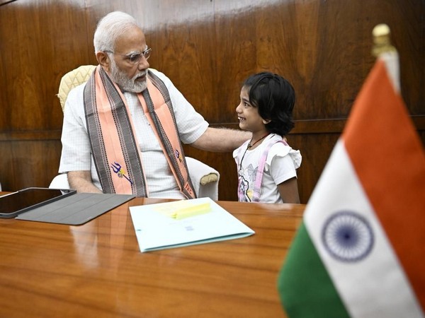 Prime Minister Narendra Modi with eight-year-old Aahana Firozia. (ANIphoto)