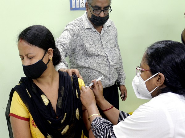 A healthcare worker administers a booster dose of COVID-19 vaccine to a beneficiary during the launch of 75 days special vaccination drive at a health centre, in Kolkata. (ANI Photo)