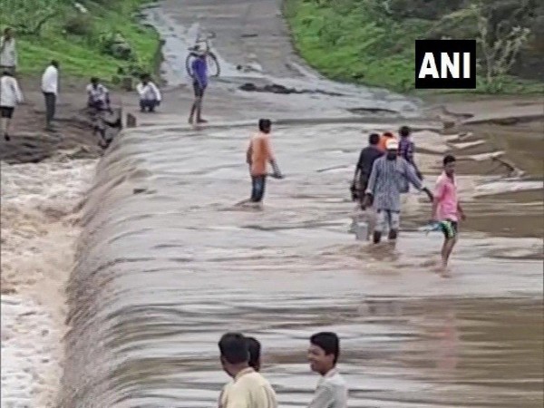 Visuals from a bridge submerged in water due to heavy rain on Sunday in Chhota Udepur. Photo/ANI