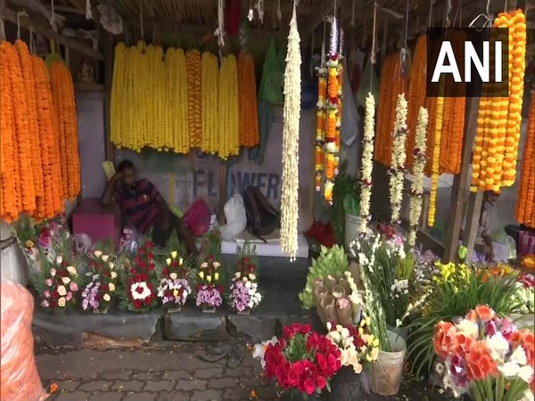 A flower seller awaits customers in Guwahati, Assam. (Photo/ANI)