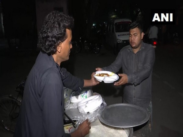 A visual of food distribution to relatives and family members of Delhi violence injured. Photo/ANI