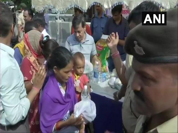People in long queues to collect flood material distributed by NTPC at Patna on Wednesday 