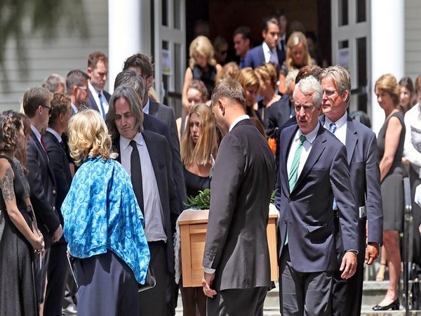 Courtney Kennedy Hill and Paul Michael Hill, carrying the casket along with other Kennedy family members, are seen after the funeral mass for their daughter Saoirse Kennedy Hill,